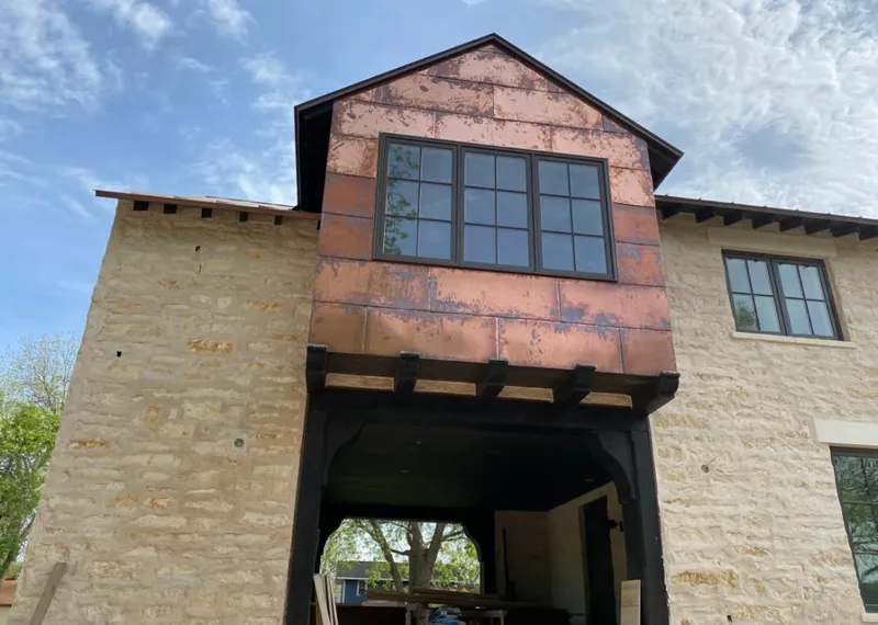 Copper metal panel facade on a stone building for Skylight Installation in Fruitland