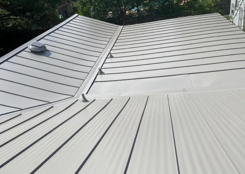 Solar attic fan installed on a metal roof for Roof Ventilation in Fruitland